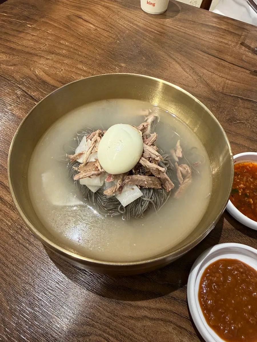 Naengmyeon broth served in a kettle