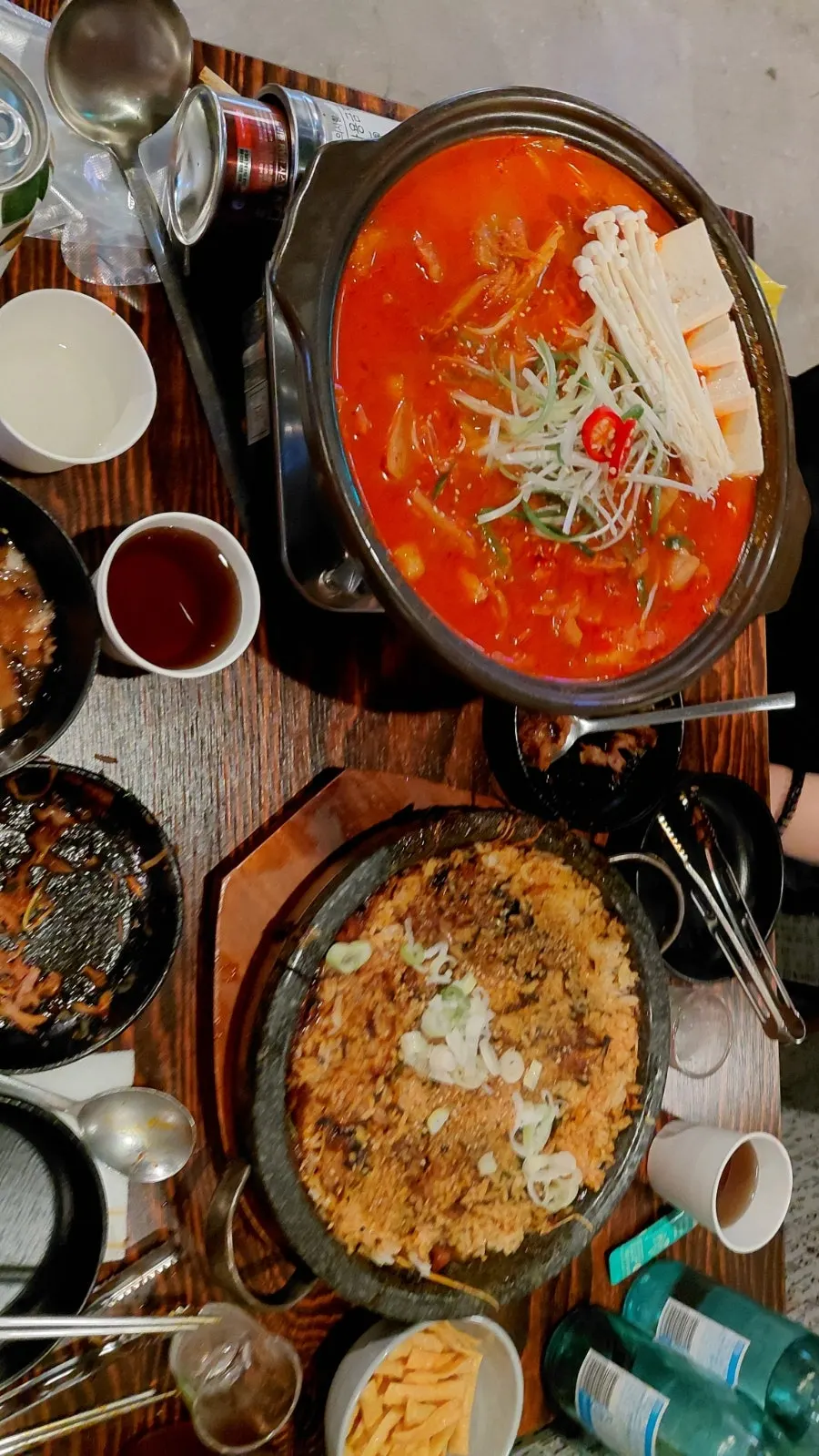 A spoonful of gimchi jjigae broth being lifted up
