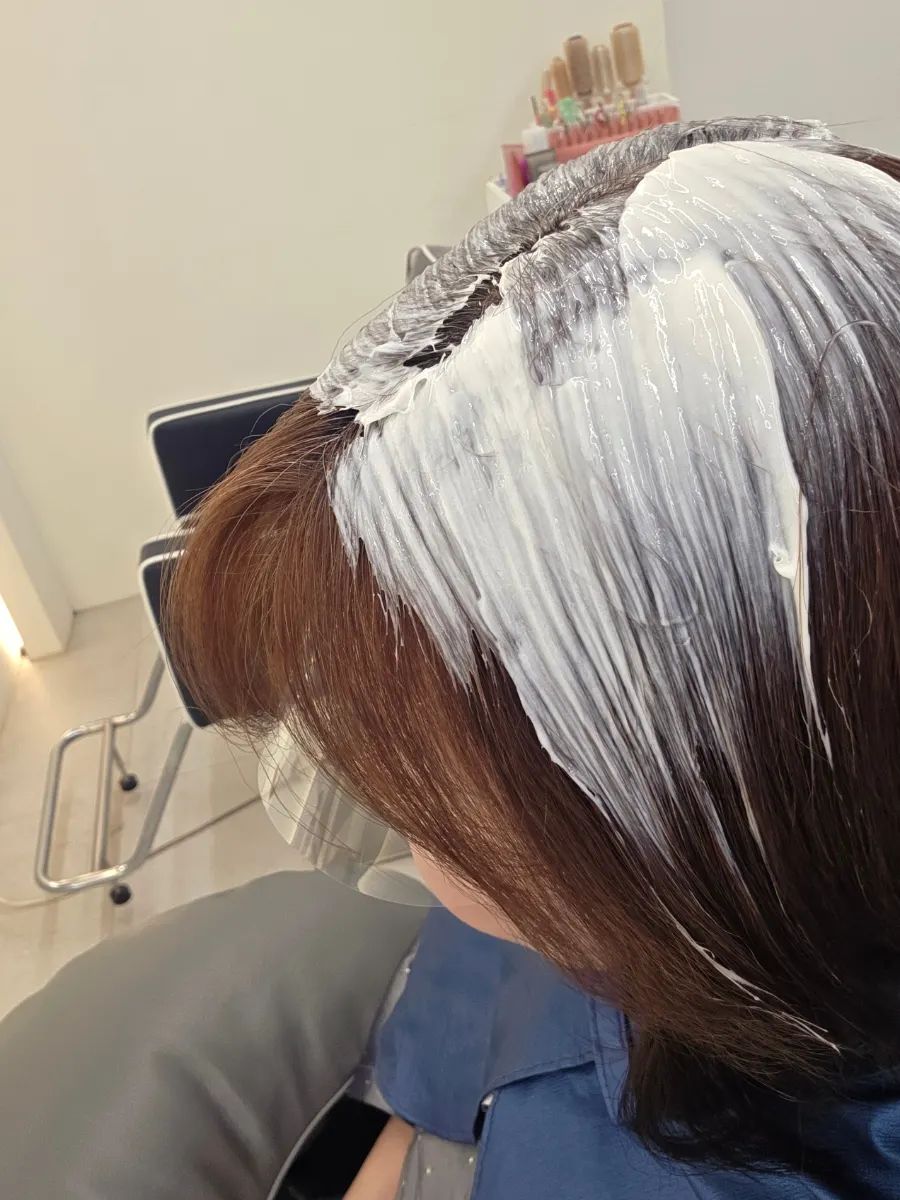 Applying color from the roots with a tint brush