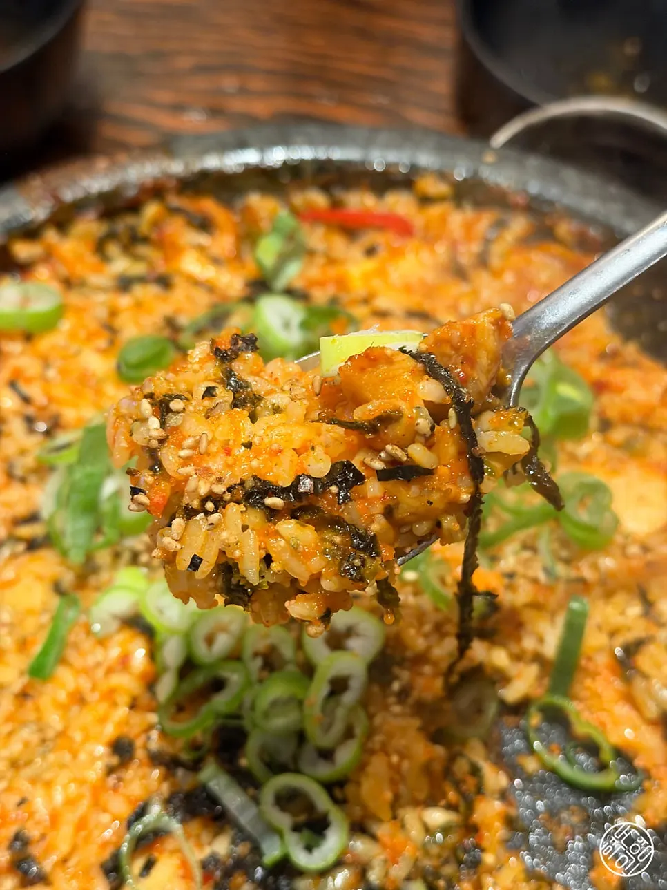 Stone-plate fried rice stirred with seaweed flakes and scallions