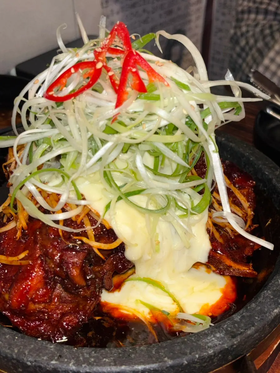 Hot-stone bone grill topped with mozzarella cheese blanket