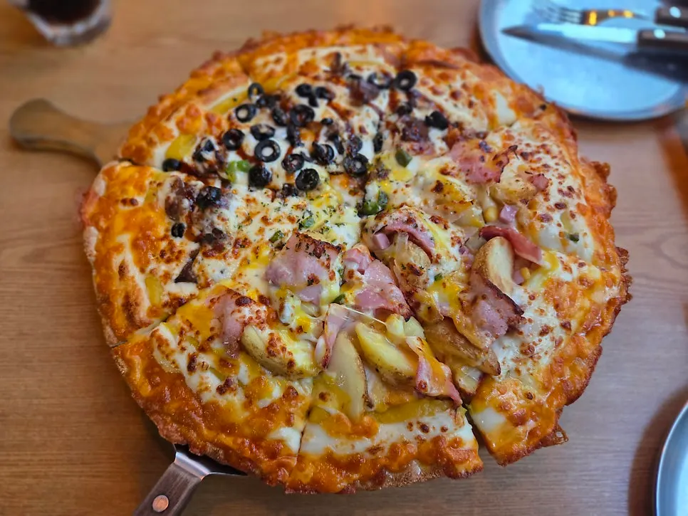 Table spread of pizza and spaghetti