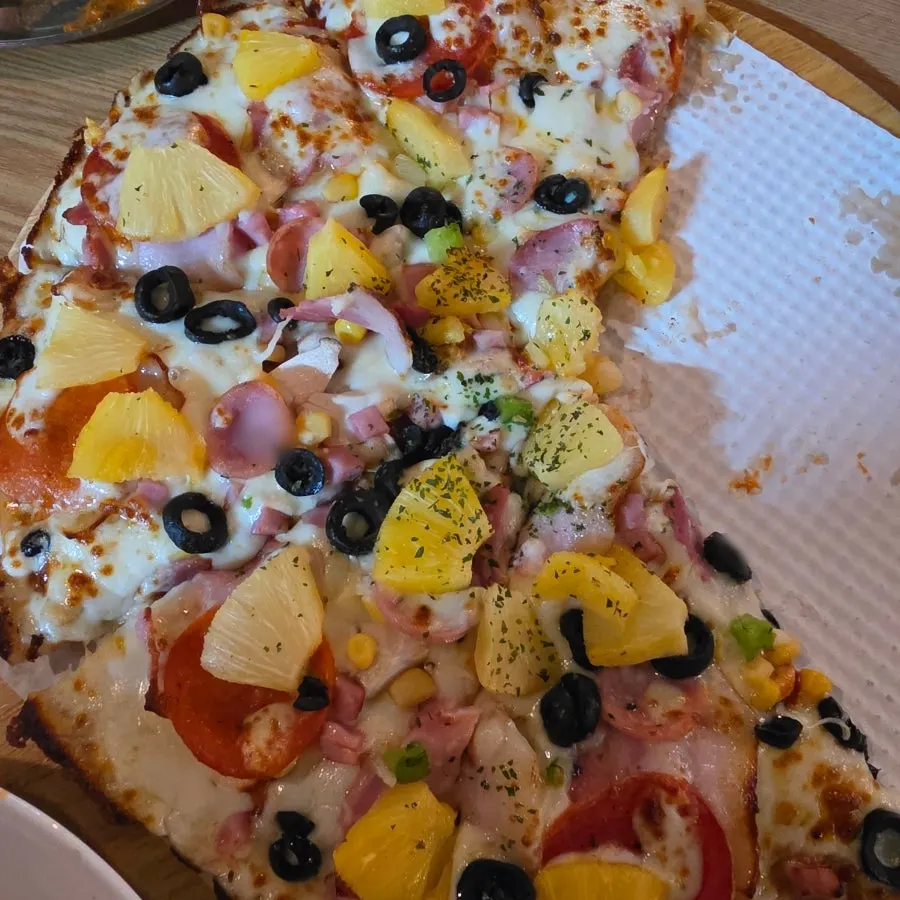 Whole pepperoni pizza served on the table