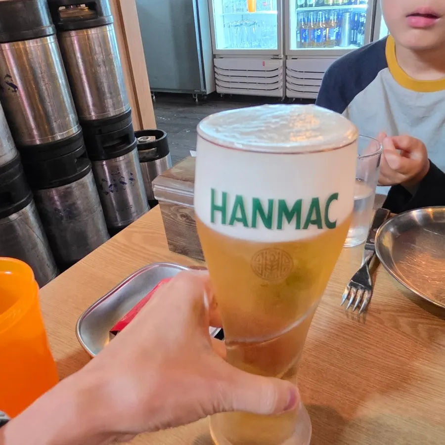 Freshly baked pizza with a cold glass of beer