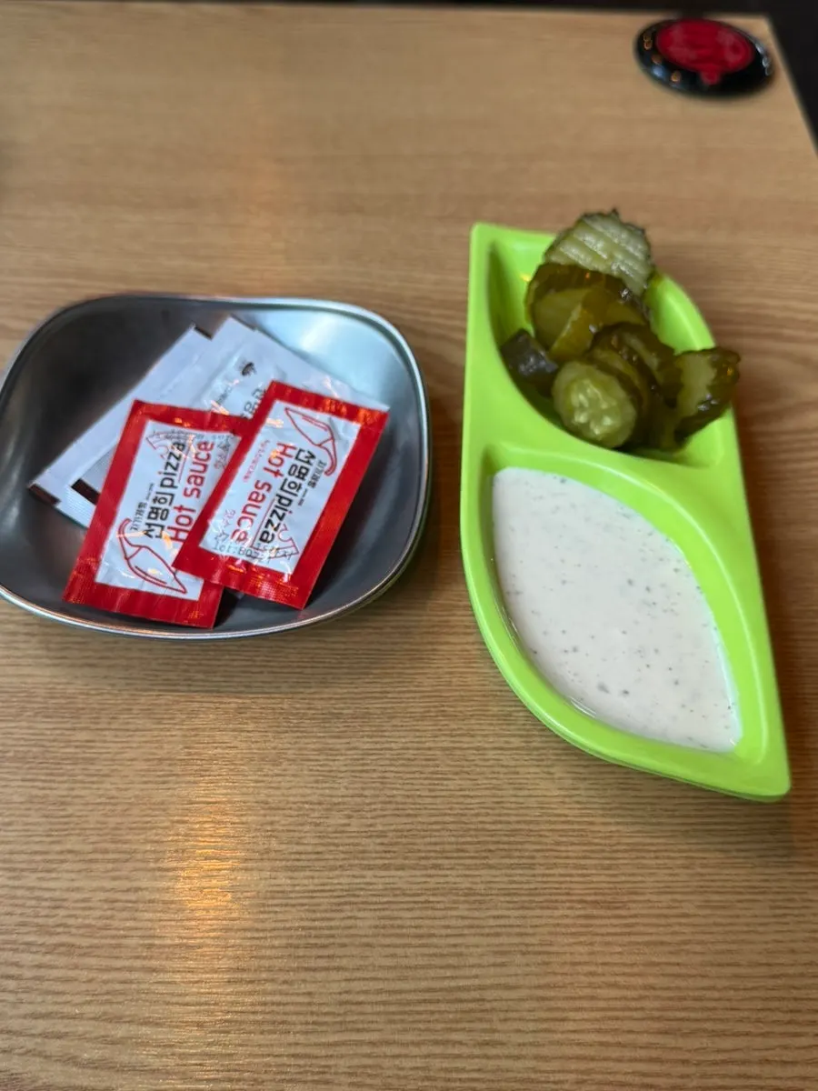 Hot sauce, parmesan cheese, garlic sauce, and pickles