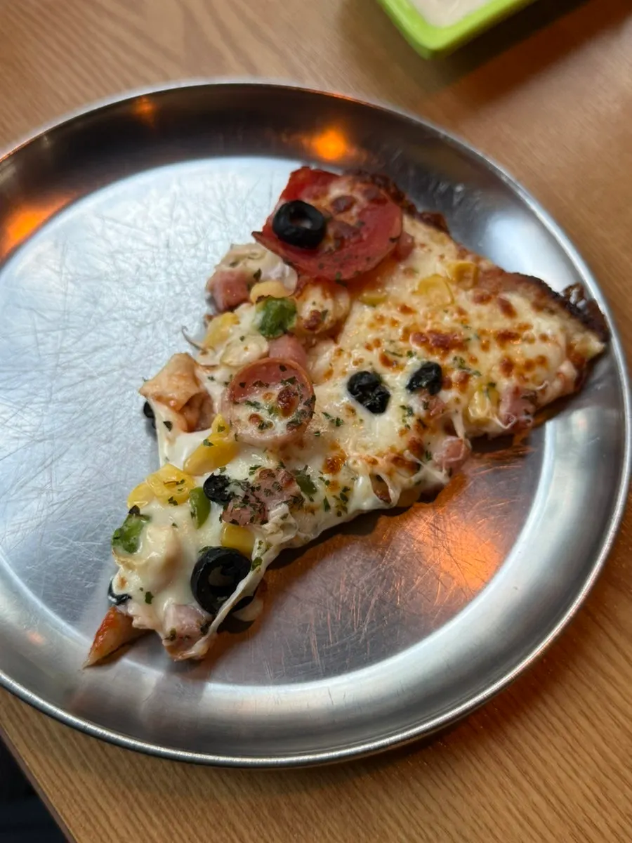Close-up of a combination pizza slice