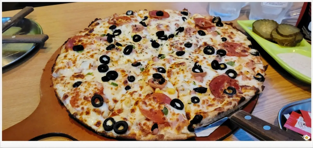 A whole combination pizza topped generously