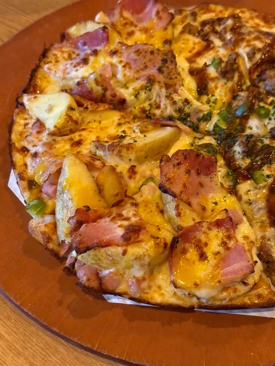 Whole freshly baked medium half-and-half pizza