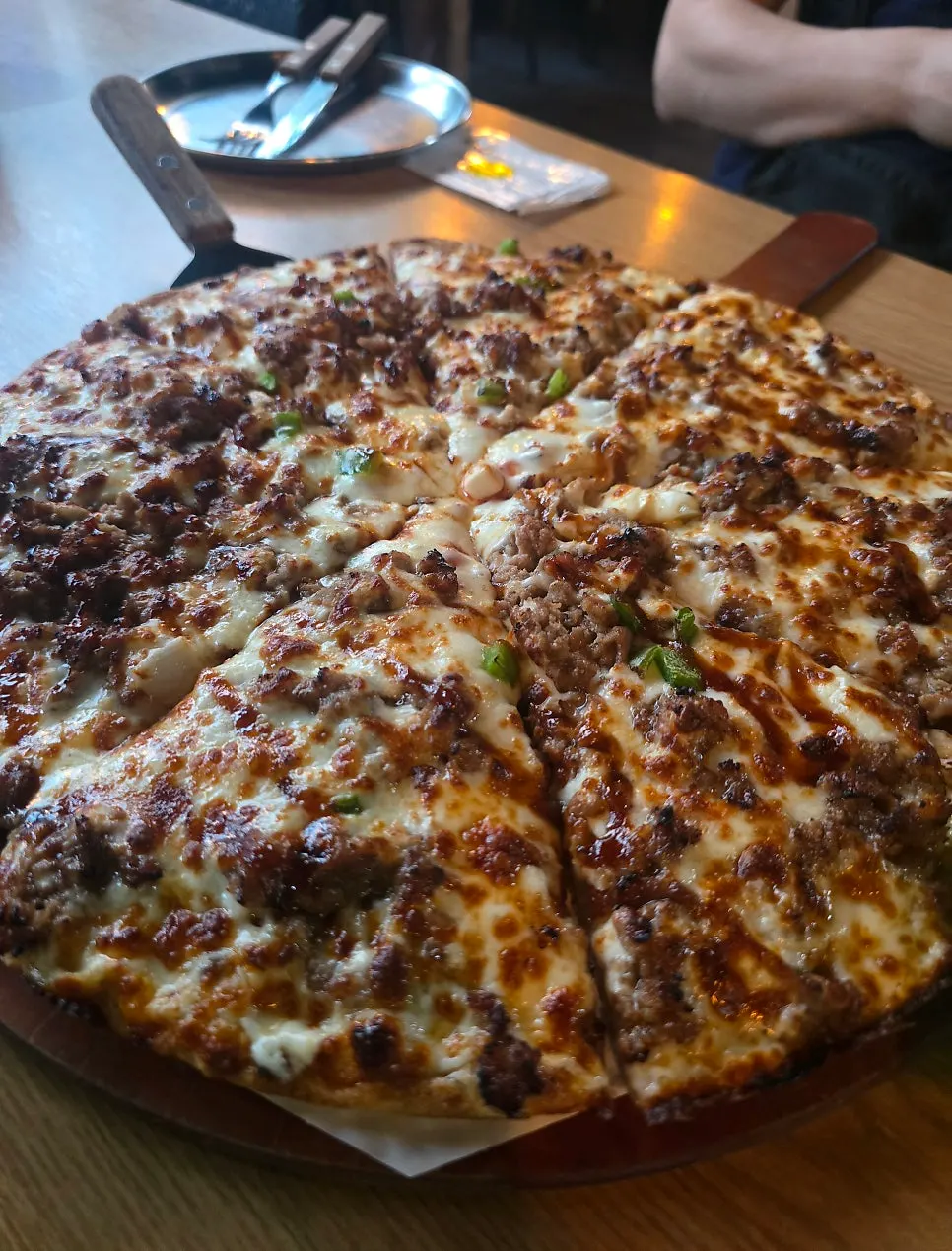A slice of bassak bulgogi pizza with stretchy cheese