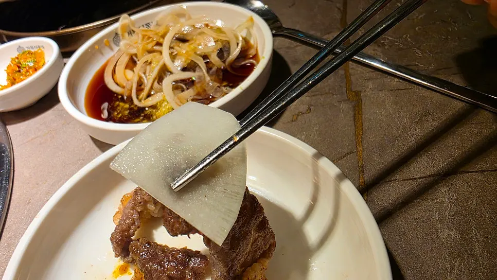 Table spread of meat with self-serve bar side dishes