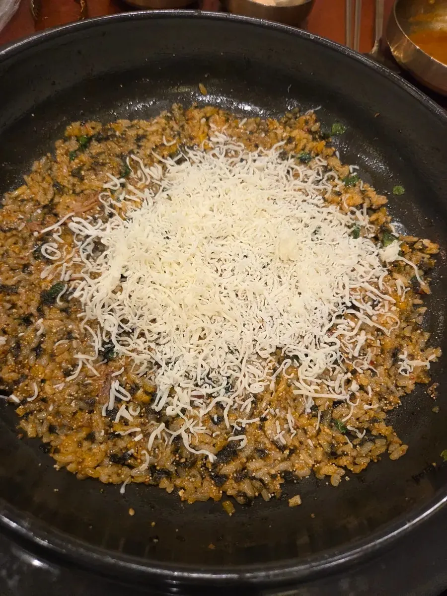 Flying fish roe fried rice being stir-fried on the griddle
