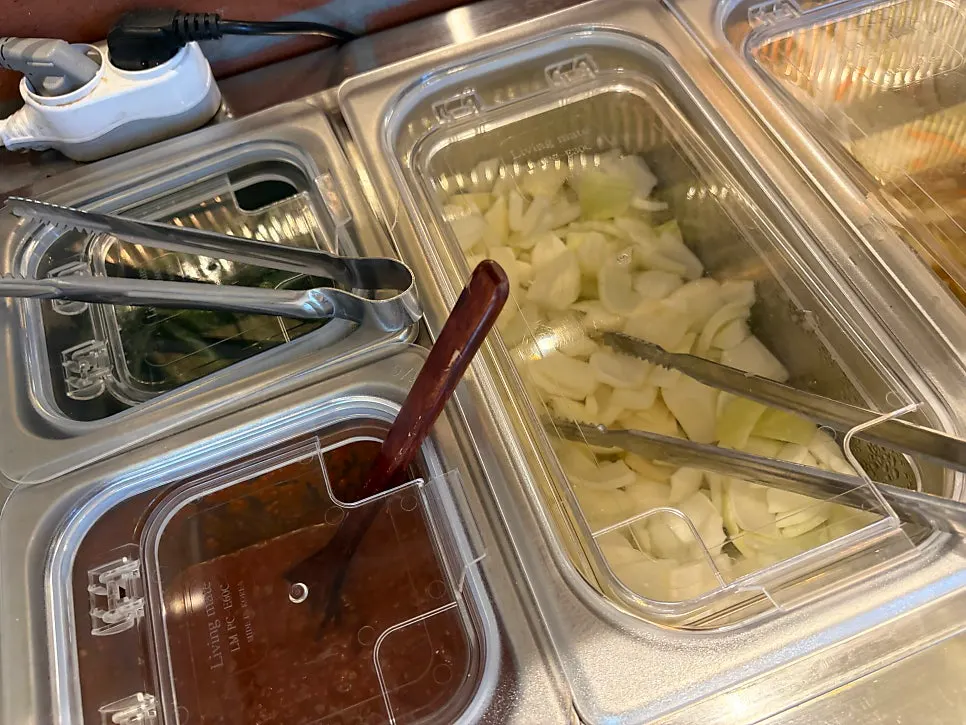 Self-service bar with onions, peppers, and kkakdugi
