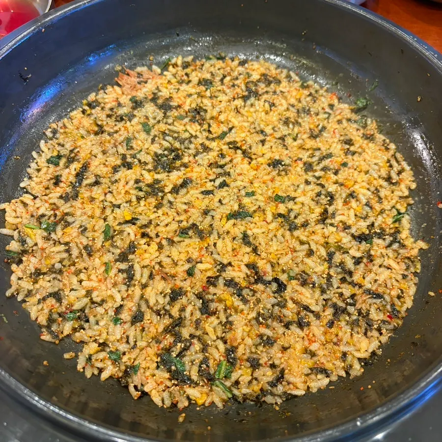 Stir-fried rice being made fresh with a chosen broth