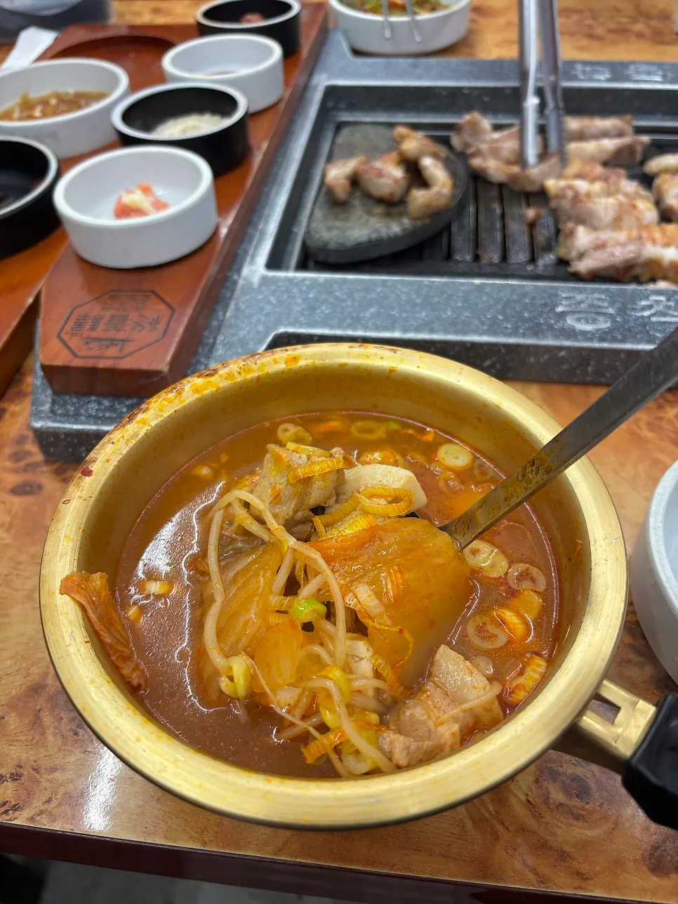Complimentary kimchi jjigae with meat inside