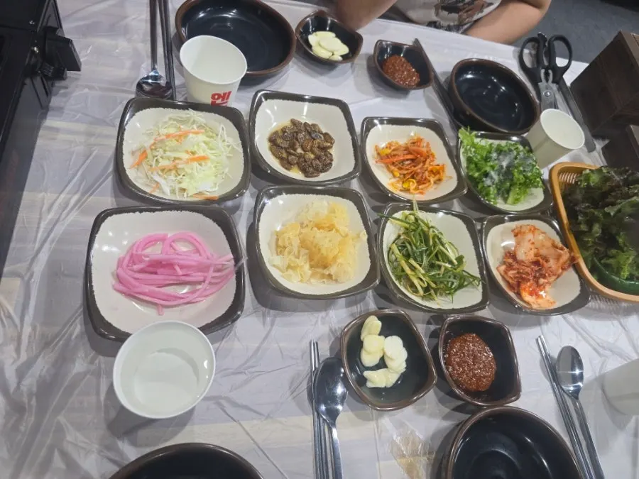 Table set with scallion shreds and pickled onions