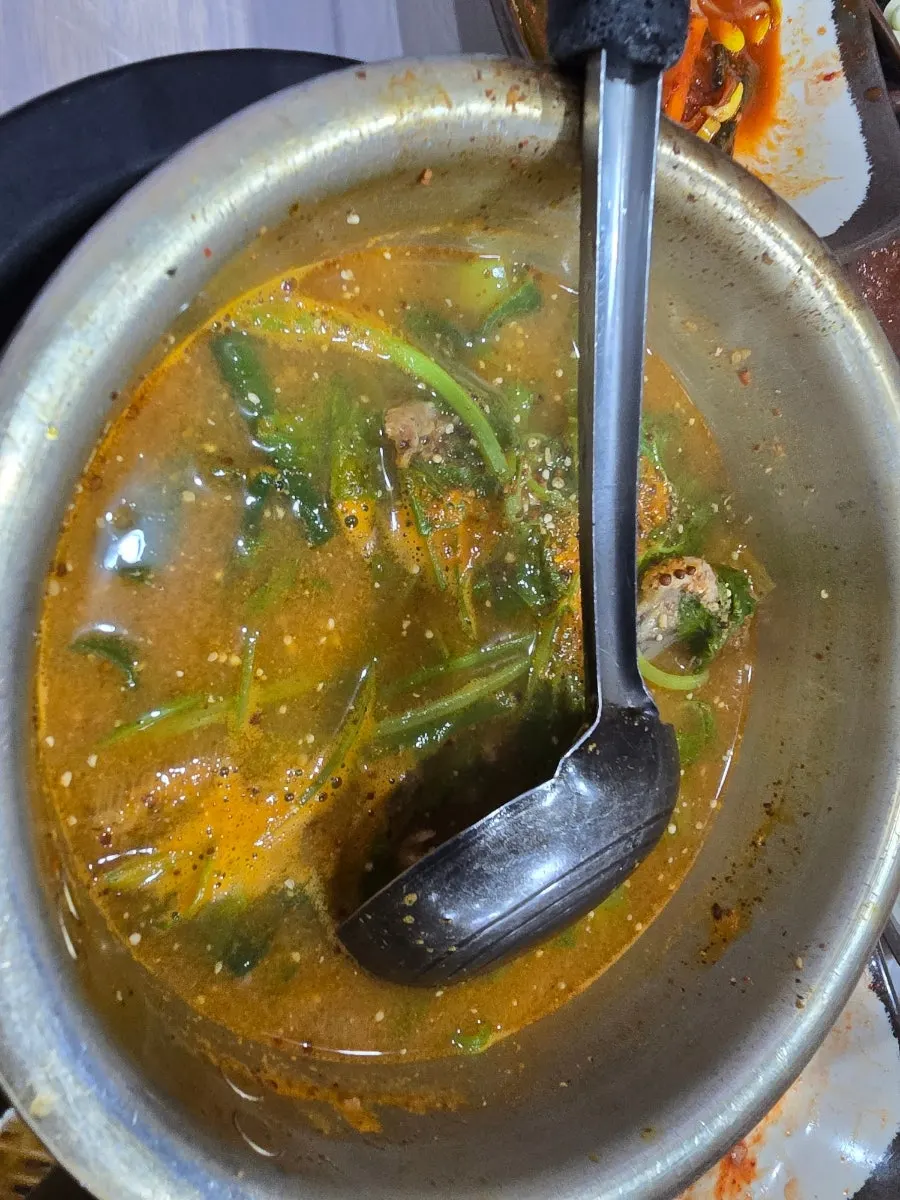 Spicy stir-fried duck served alongside bowls of rice