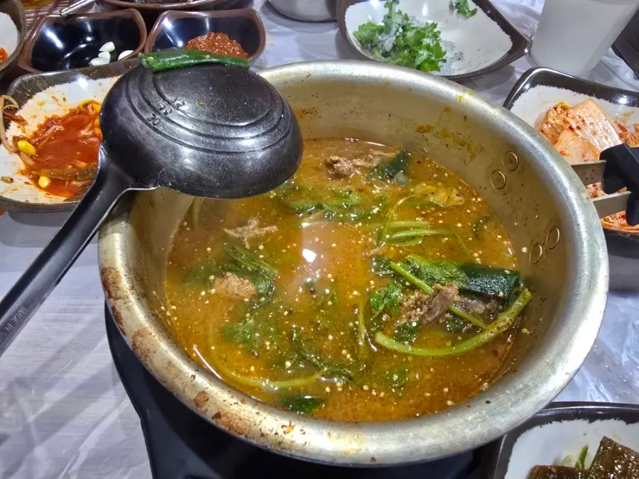 Duck meat and minari scooped from the duck soup