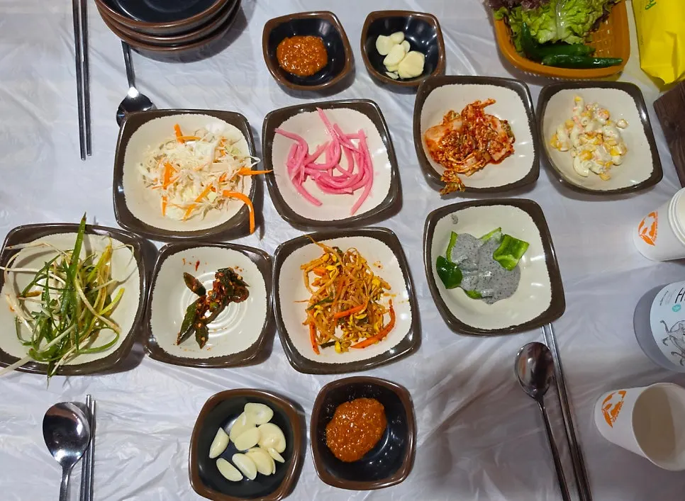 Generous banchan spread with kimchi and seasoned vegetables