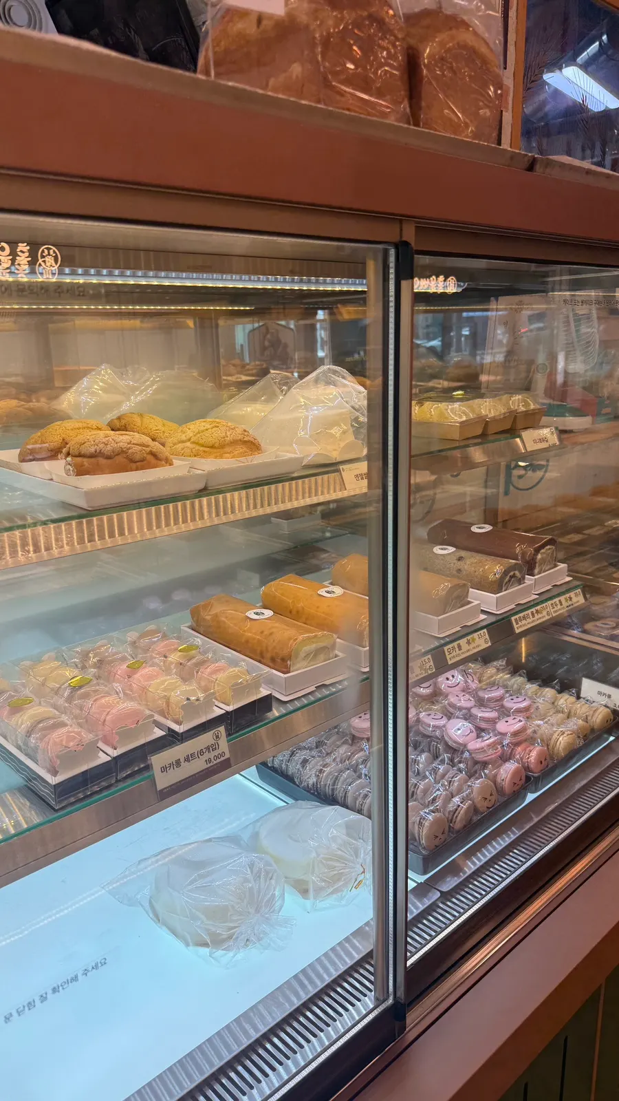Case with cakes, macarons, and roll cakes