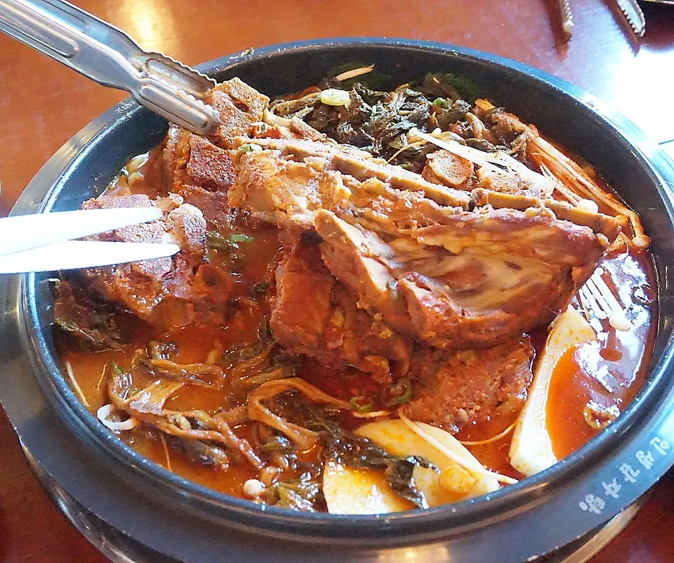 Large gamjatang bone separated into bite-sized pieces by staff