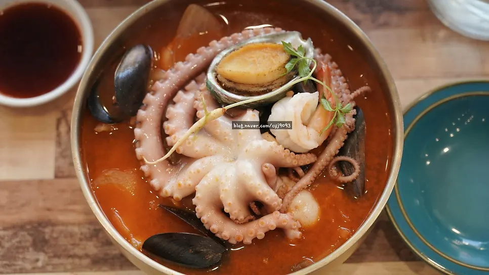A chopstick-full of jjambbong with whole octopus lifted out