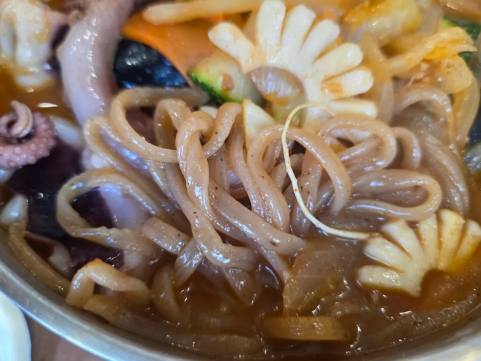 Chaga mushroom noodles lifted out of the jjambbong