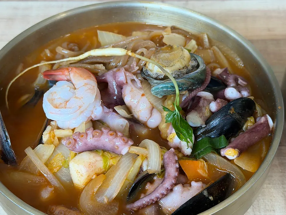 Octopus-abalone jjambbong topped with whole octopus and abalone