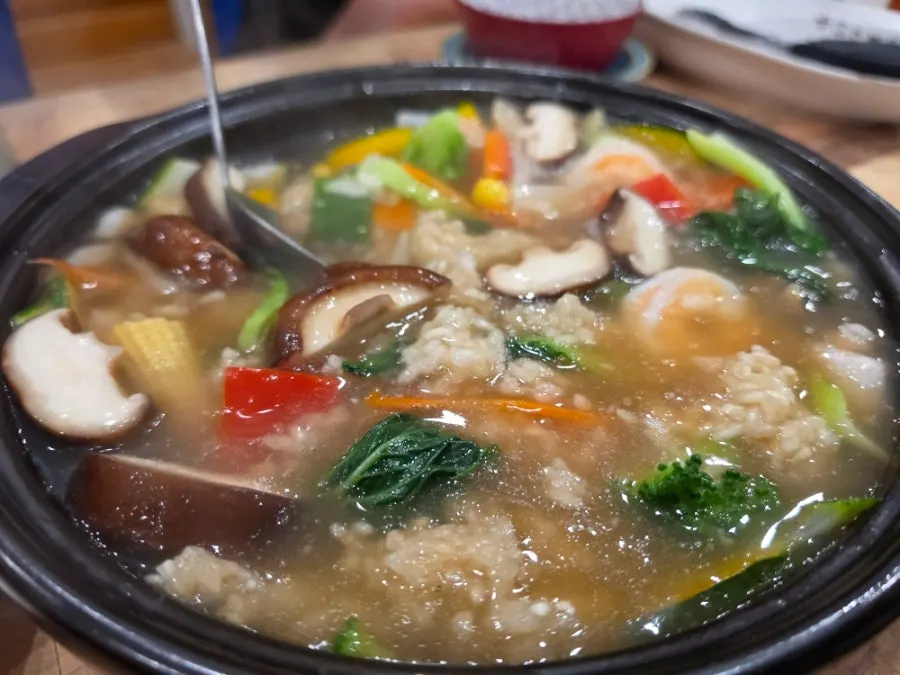 Seafood scorched rice soup with seafood sauce poured over large scorched rice