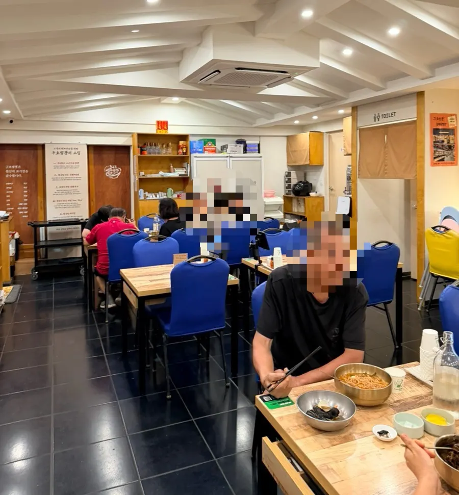 Spacious interior of Gupo Jjambbong with plenty of tables