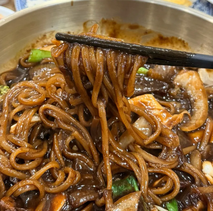 Seafood jjajang with sauce clinging thickly to the noodles
