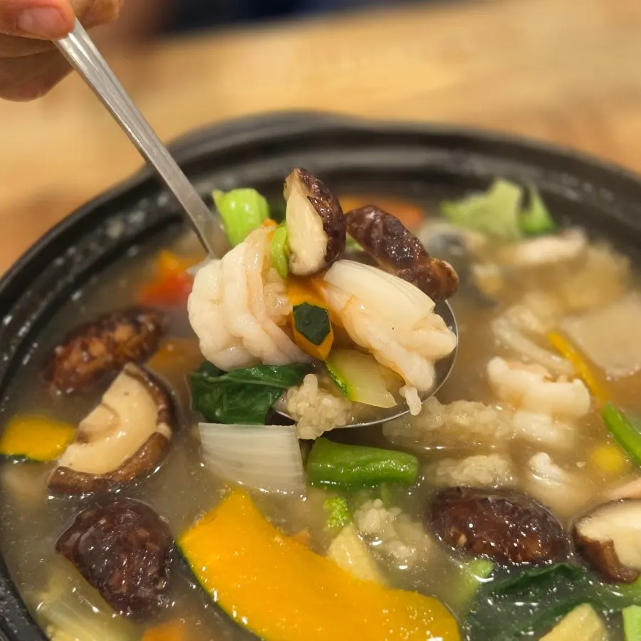 Seafood scorched rice soup topped with two large shrimp