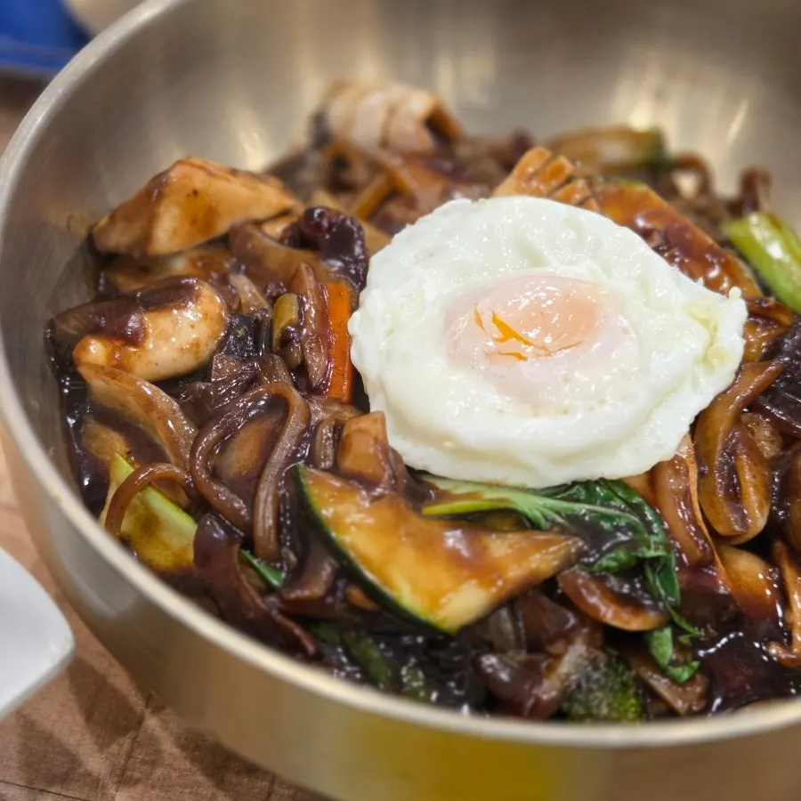Seafood platter jjajang topped with a fried egg