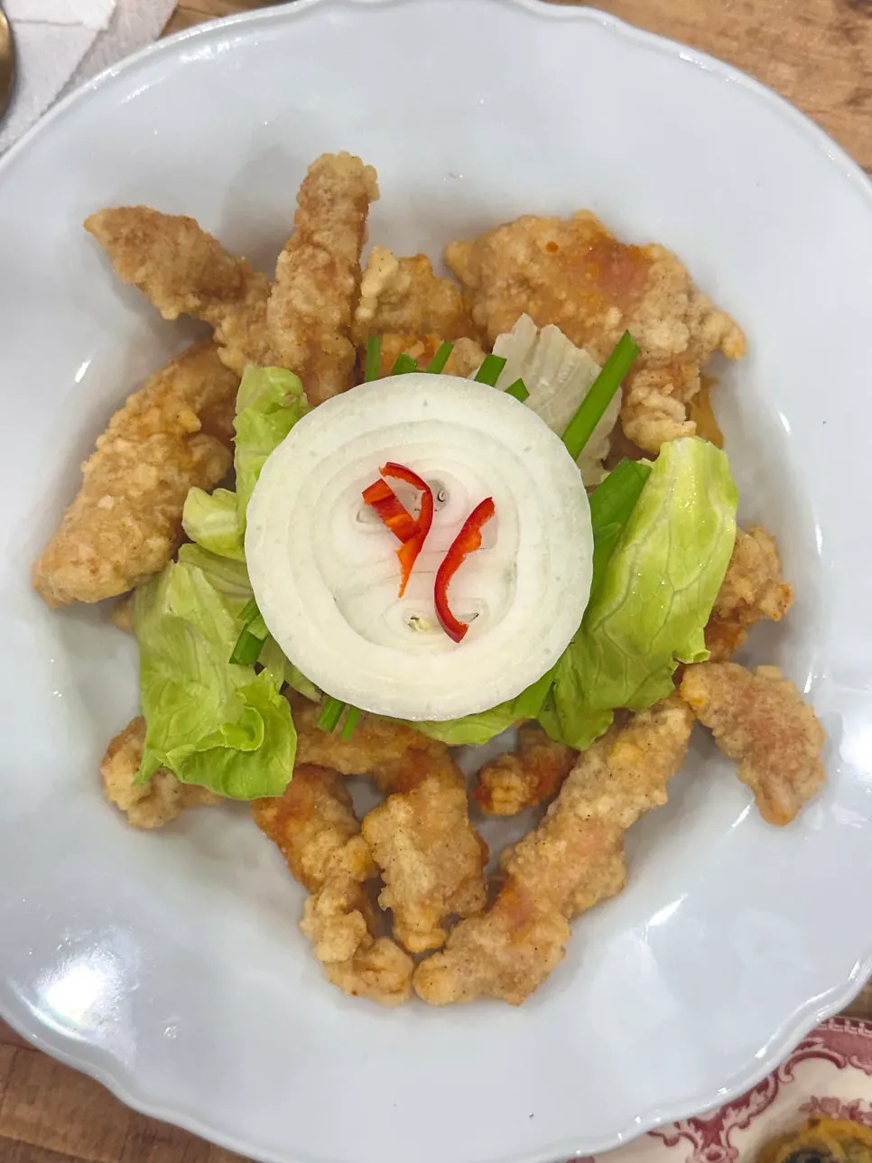 Small tangsuyuk topped with lettuce and chives