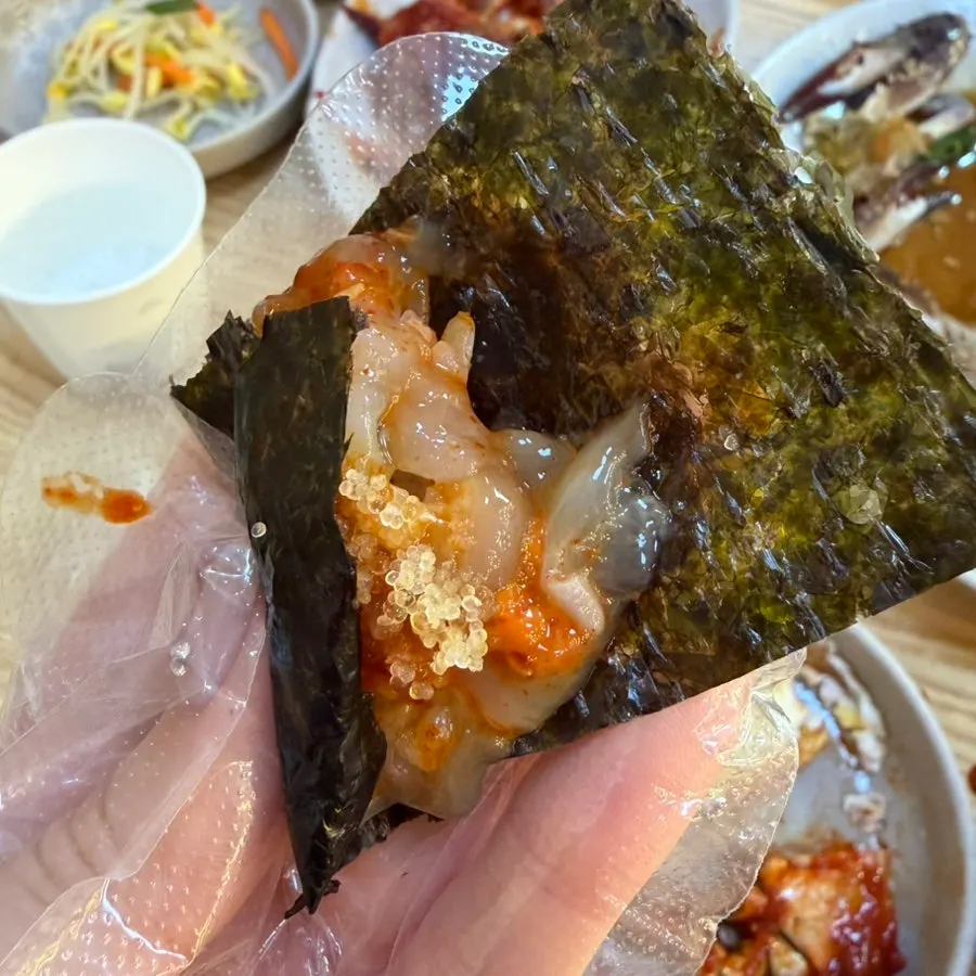 Picking up a piece of marinated crab