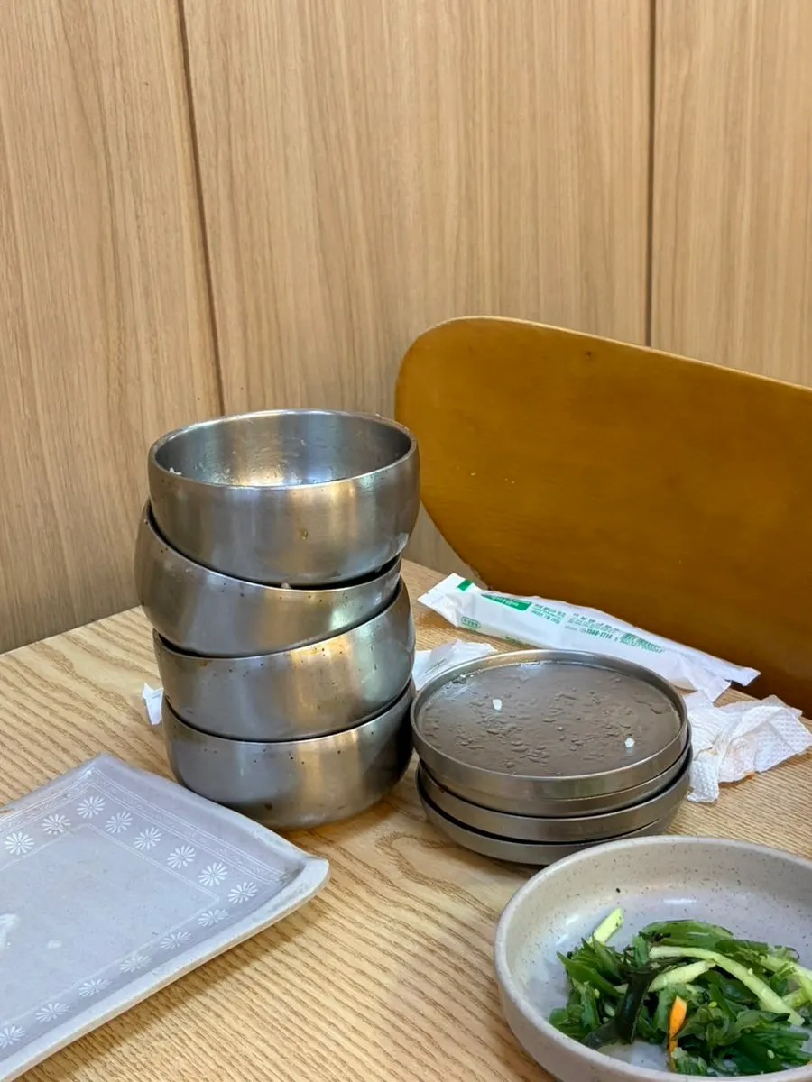 Table stacked with four emptied rice bowls