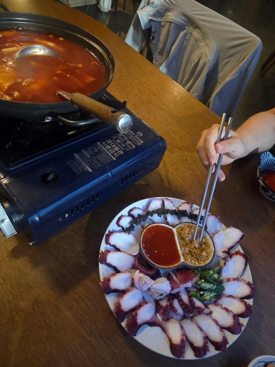 Digging into a plate of food at Muje