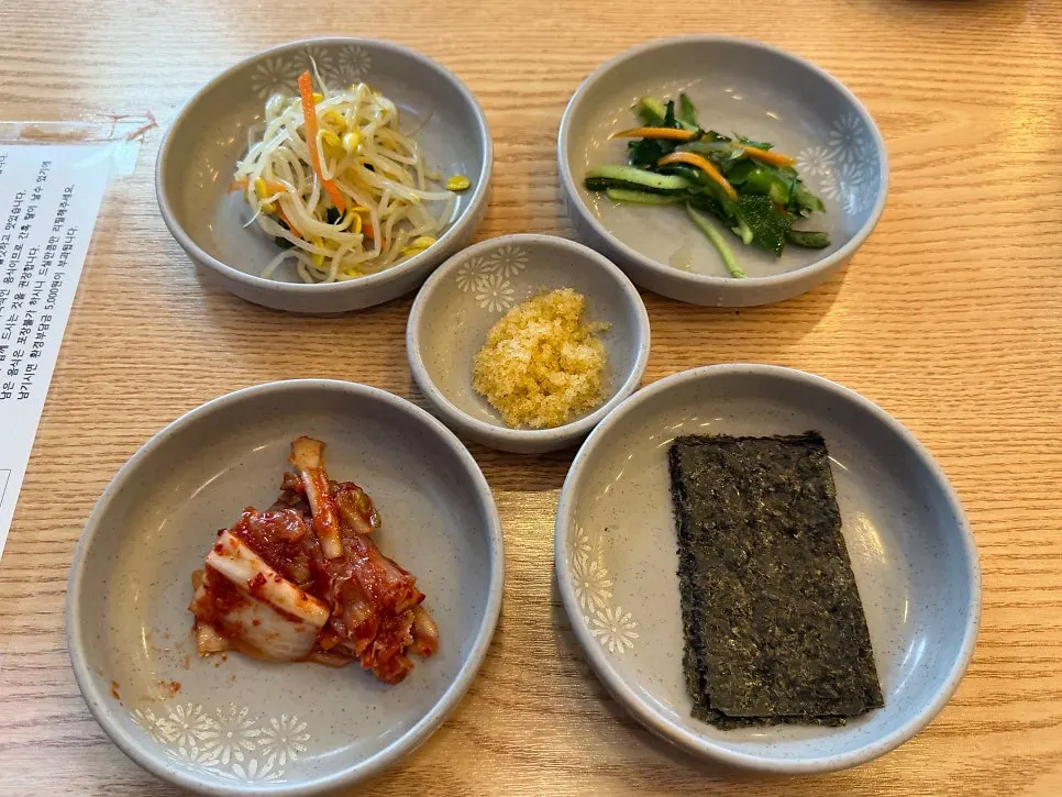 Banchan spread with seaweed, flying fish roe, kimchi, and more