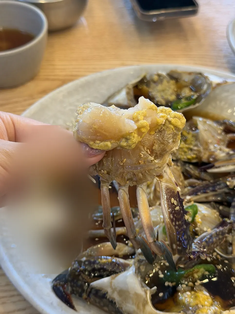 Soy crab with meat popping out after pressing the body