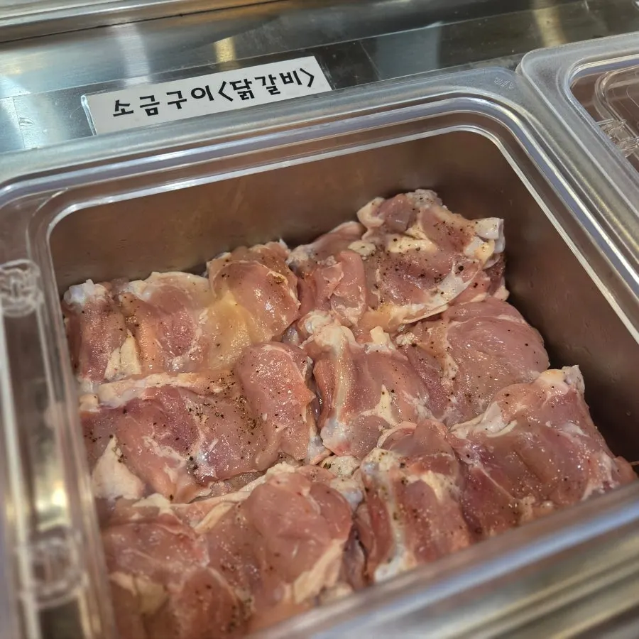 Meat fridge stocked with dakgalbi and pork cuts