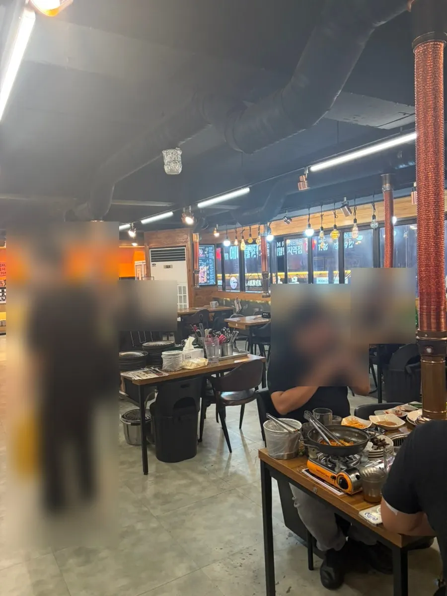 Interior of the all-you-can-eat grill restaurant with wide table spacing