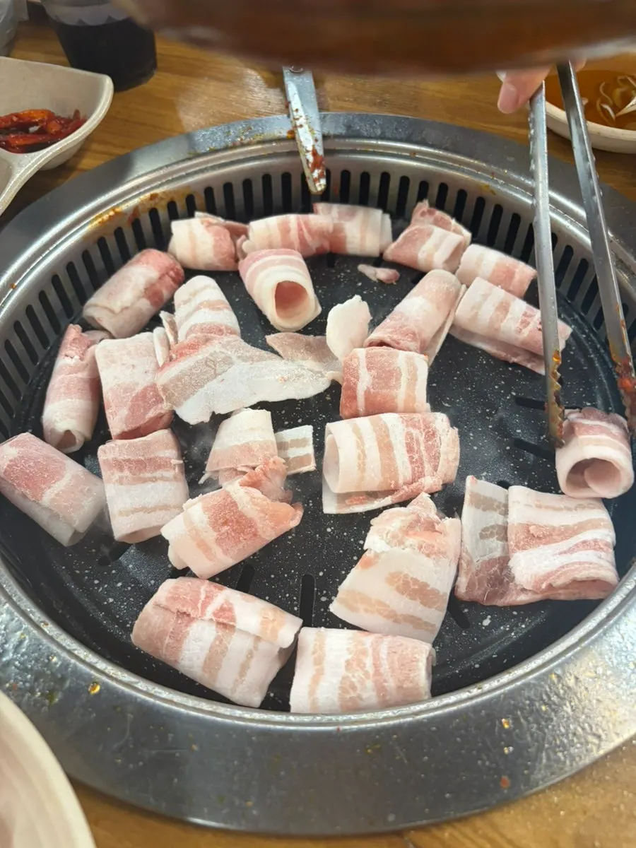 Seasoned dakgalbi wrapped in a lettuce leaf