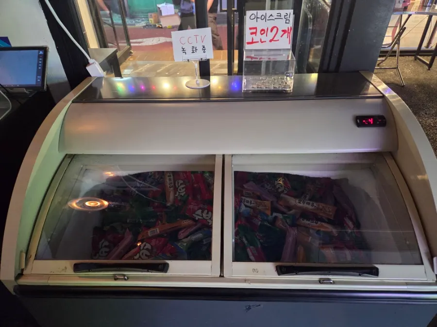 A claw machine played with coins