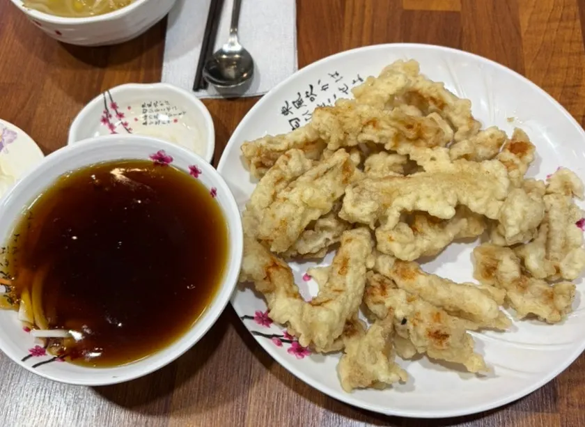 Table spread of the sweet and sour pork and meal set for two