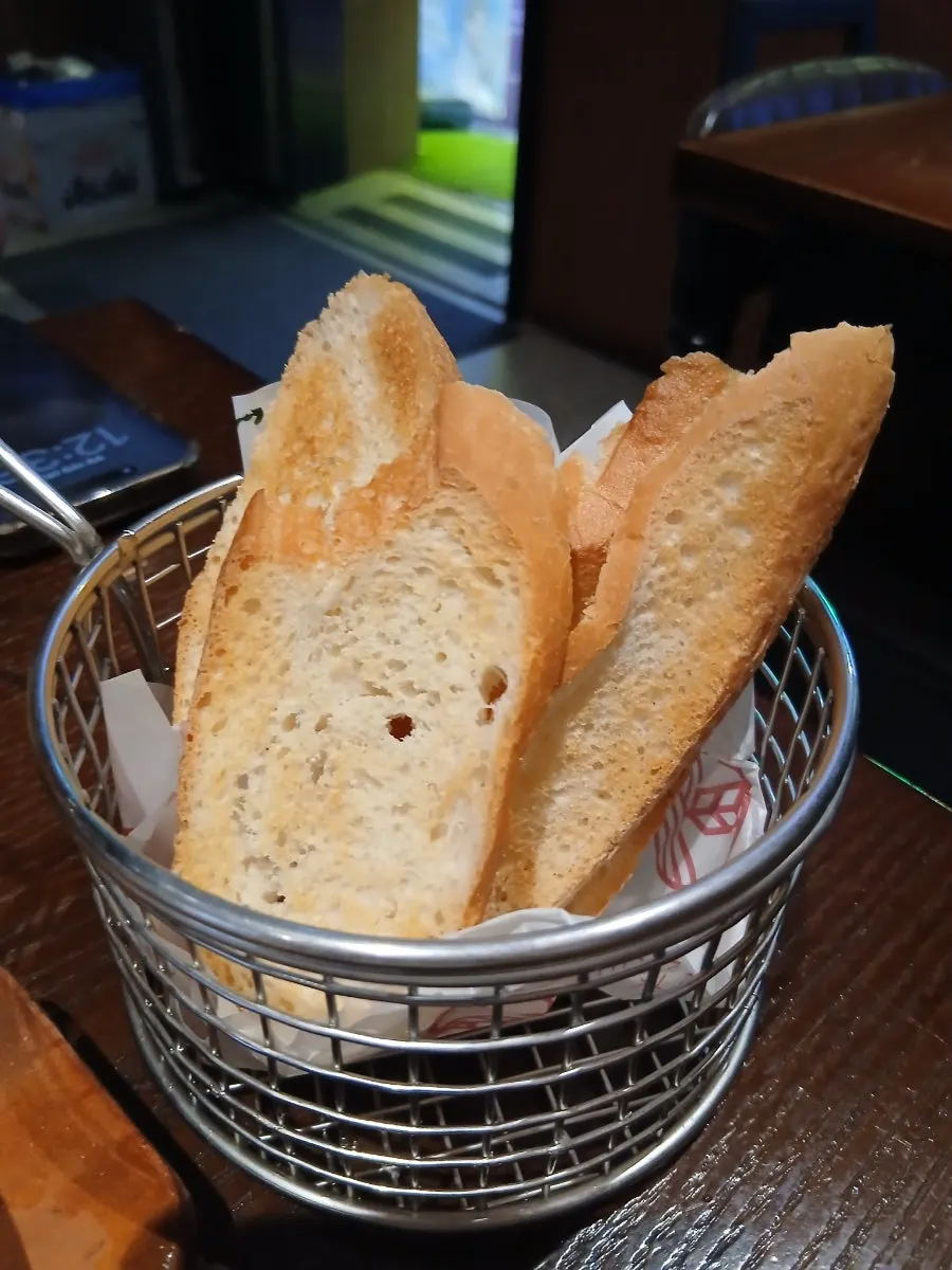 Shrimp and garlic piled on baguette bread