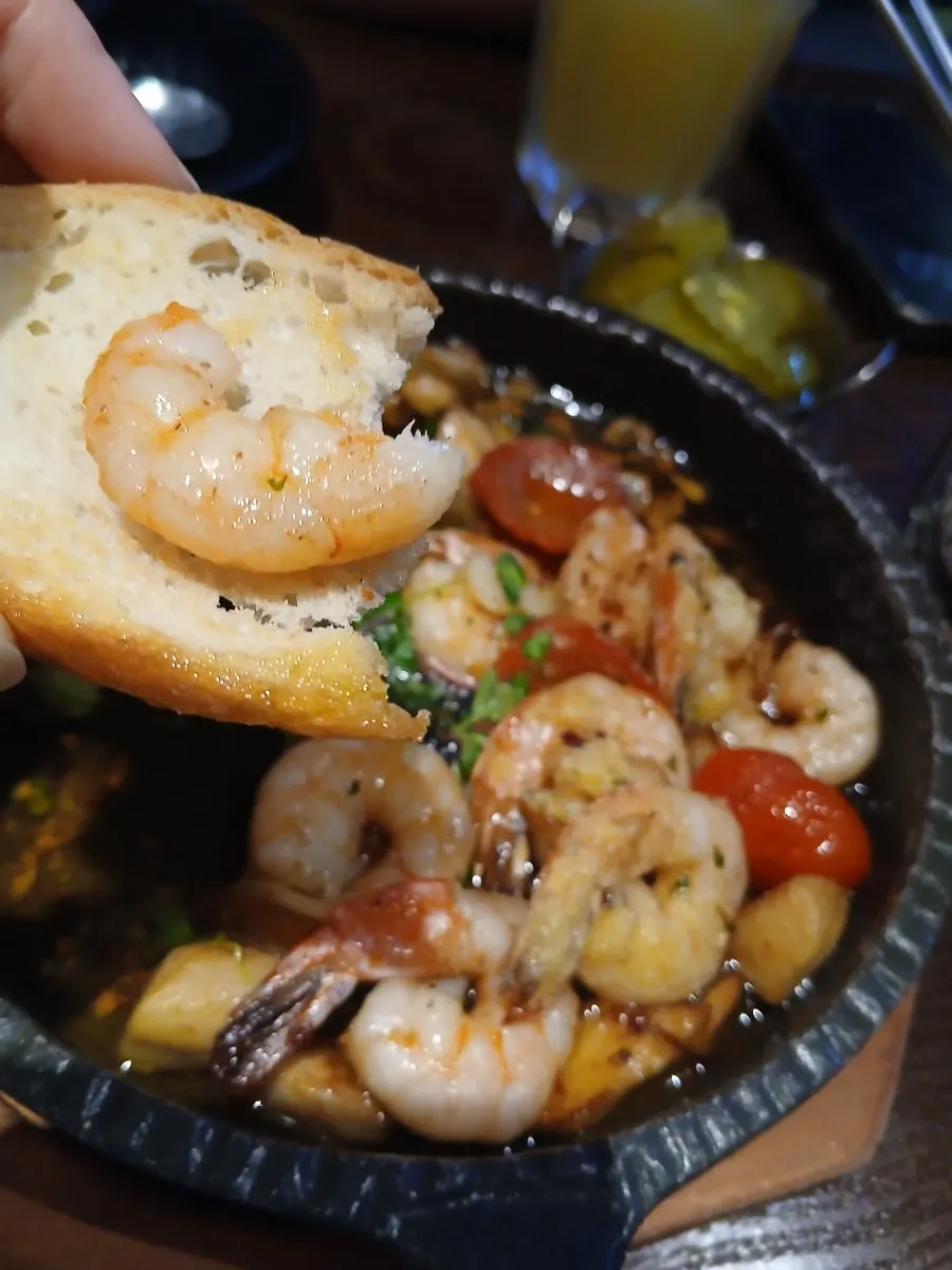 Table with gambas al ajillo and injeolmi bingsu together