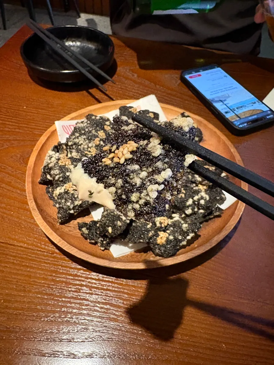 Dipping gimbugak into the sauce