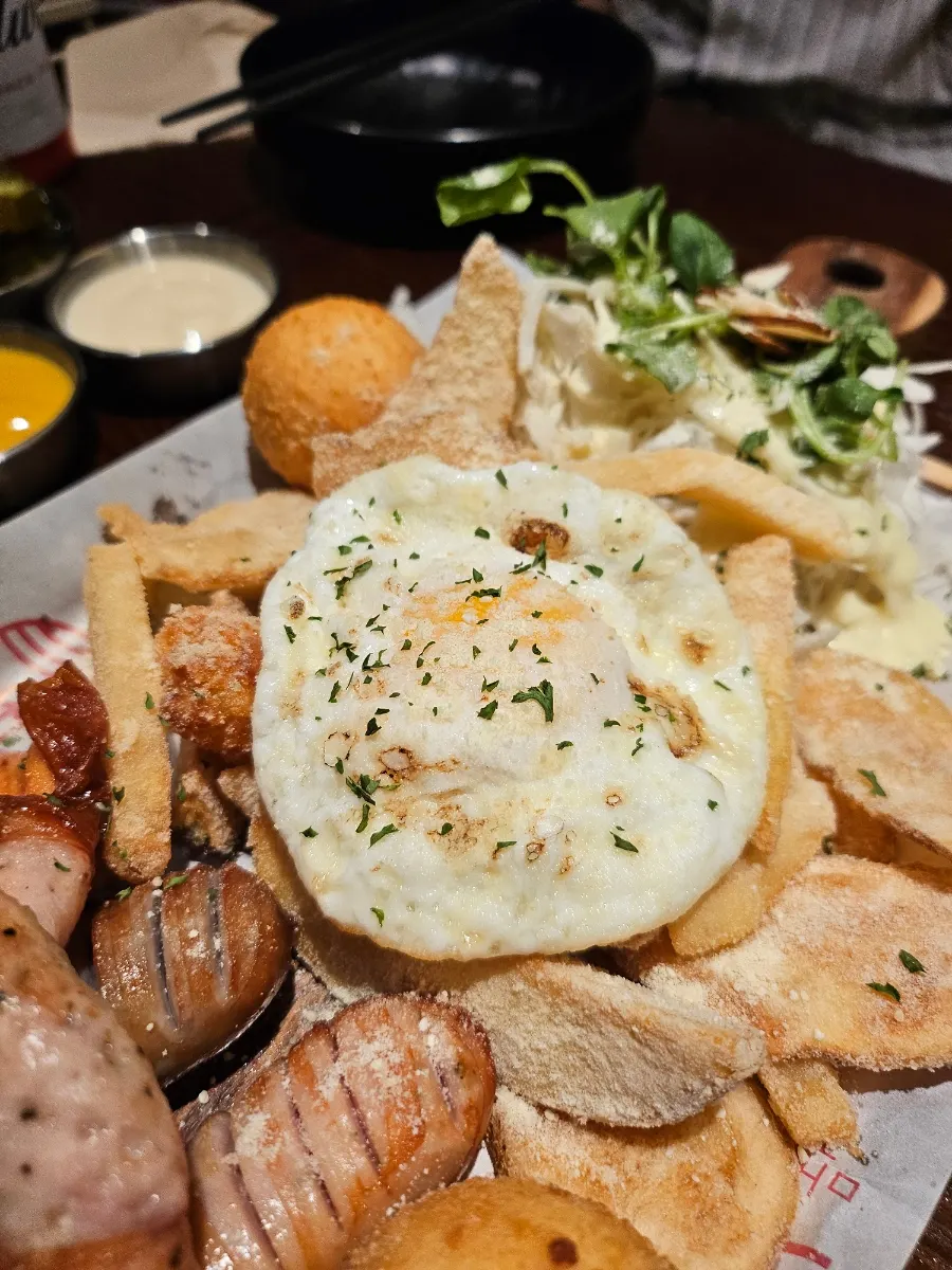 Sausage platter and fries spread on the table