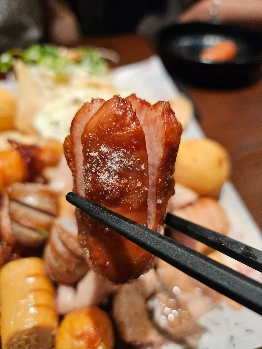 Sausage dipped into soft-boiled egg yolk