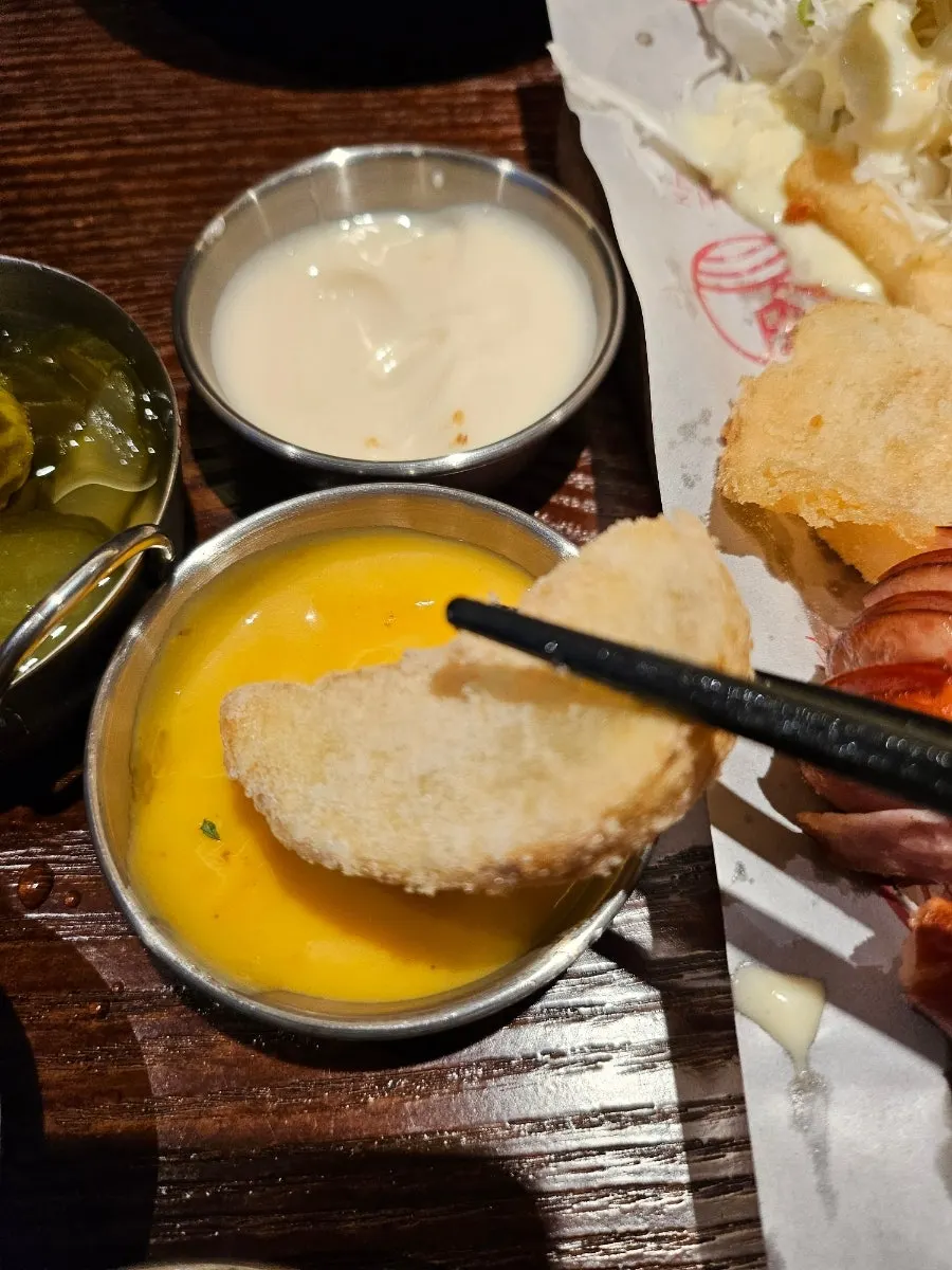 Picking up a sausage from the platter