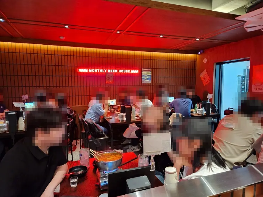 Interior of Monthly Beer packed with customers on a weekday evening